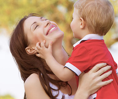 A Women and a Cute Child The toddler and his mother are playing sweetly.