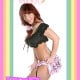 A Sissy Girl is standing there wearing the pink robe and holding a purse.