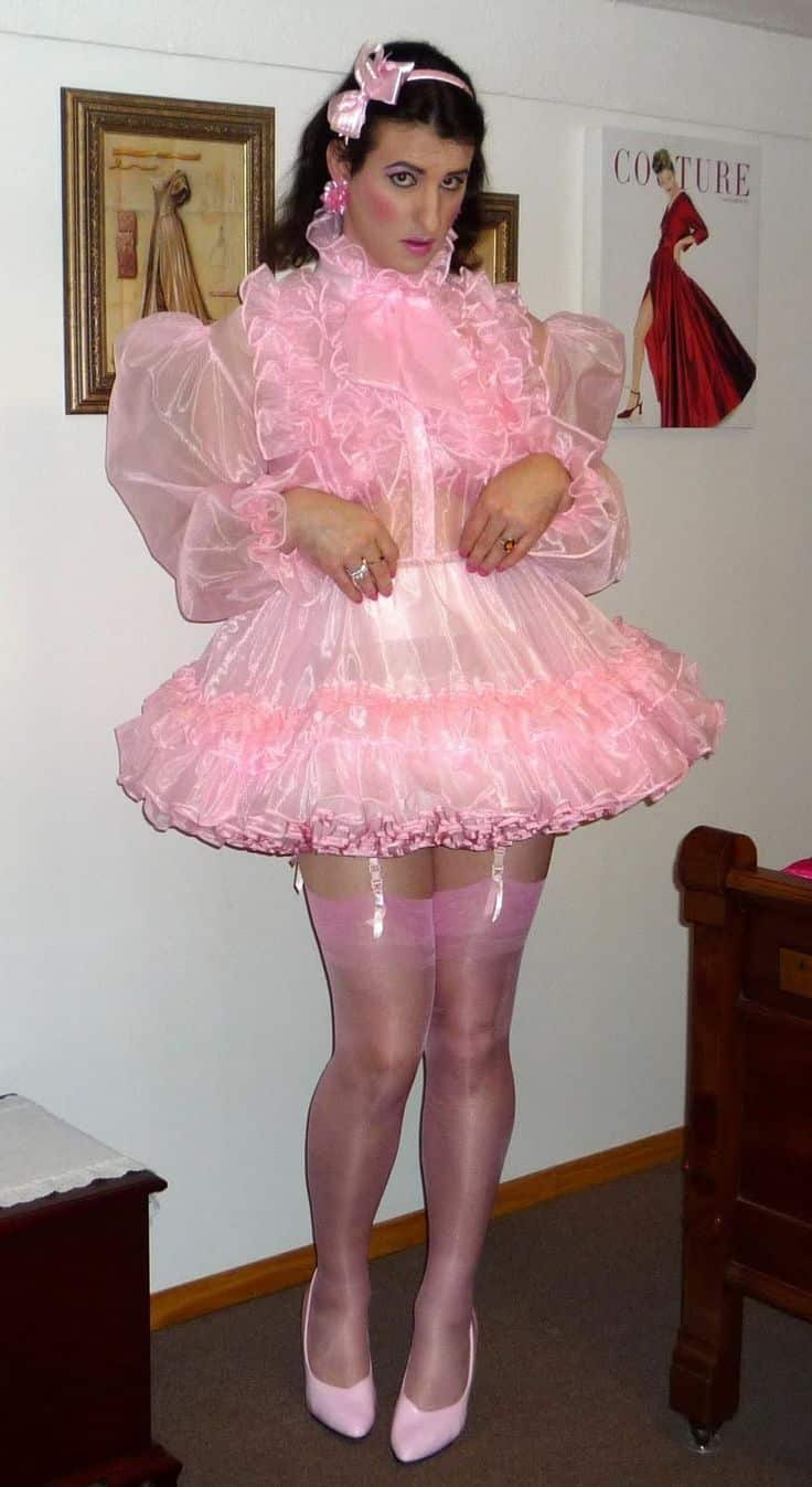 The boy was dressed in a pink sissy adult dress, high-heeled slippers, and stocks.