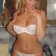 Standing for the picture shoot, a lovely girl wearing white drees for lingerie looks hot and seductive.