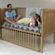 There are two individuals sleeping in the baby adult crip, which is referred to as an ABDL baby crib.
