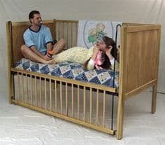 There are two individuals sleeping in the baby adult crip, which is referred to as an ABDL baby crib.