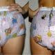 A front and black diaper girl is barefoot and standing on the ground.
