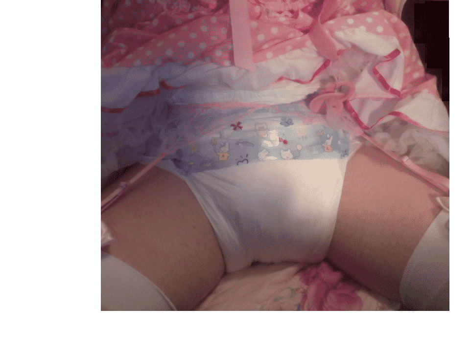 A baby boy is lying in bed wearing a gorgeous pink alluring dress and a white diaper.