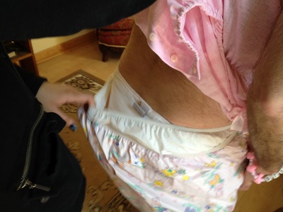 He wears pink clothing and the Swedish Diaper.