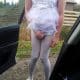 She's approaching the car with a diaper and pink sissy dress.