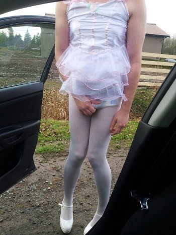 She's approaching the car with a diaper and pink sissy dress.