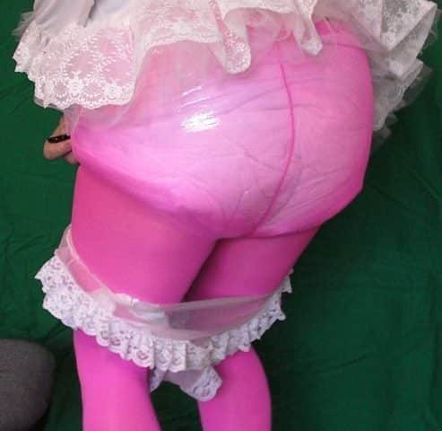 A Pink Butt man is posing for shots while standing on the ground and donning the pink attire.