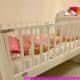 A man is lying on the Sissy Baby Crib, which is maintained in the room.