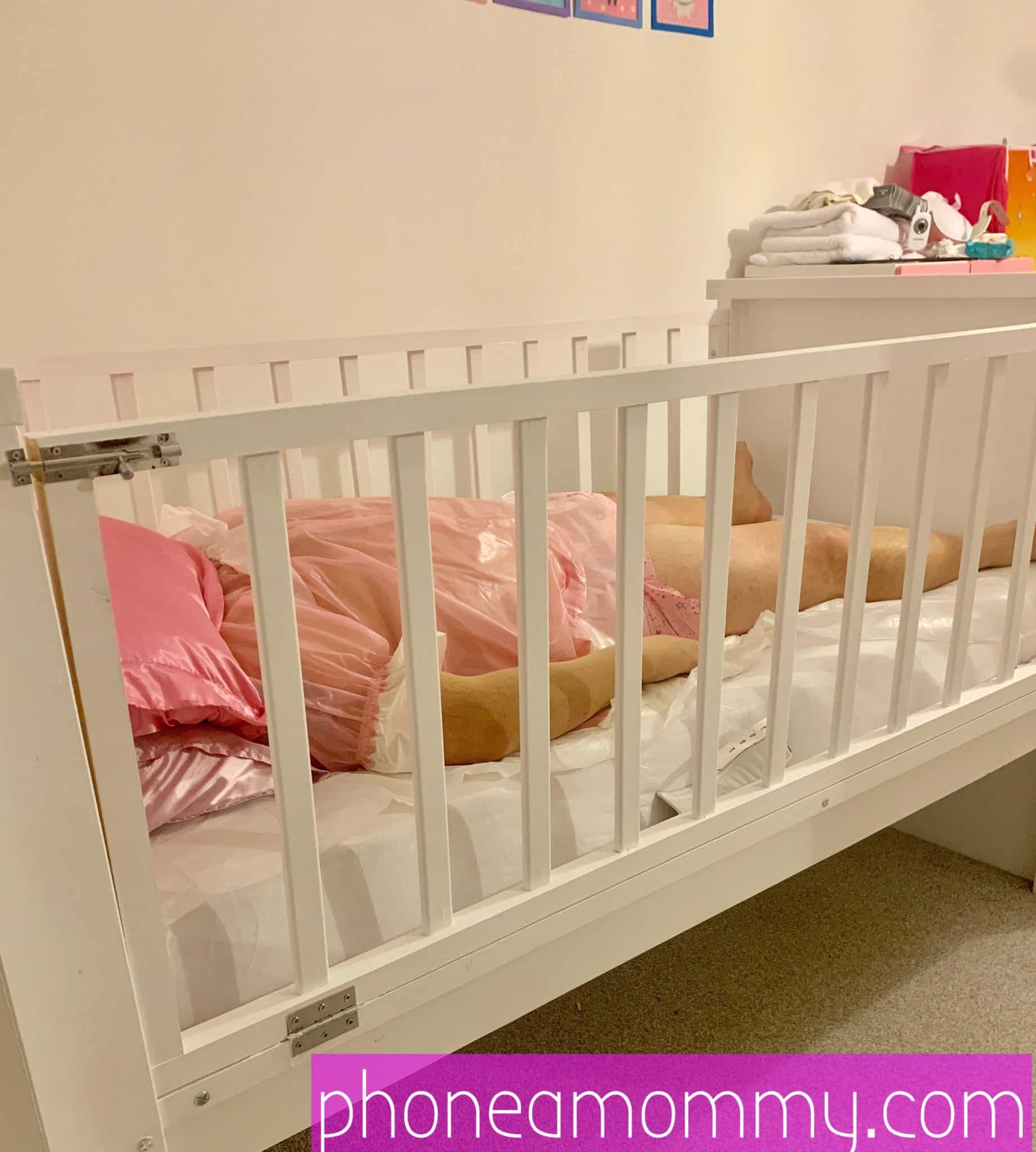 A man is lying on the Sissy Baby Crib, which is maintained in the room.