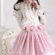 sissyStanding on the ground, the Sissy Fetish model is donning the white and pink clothing for the photo session.