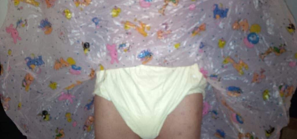 For the photo shoot, a Diaper Fetish man is posing while standing on the ground.